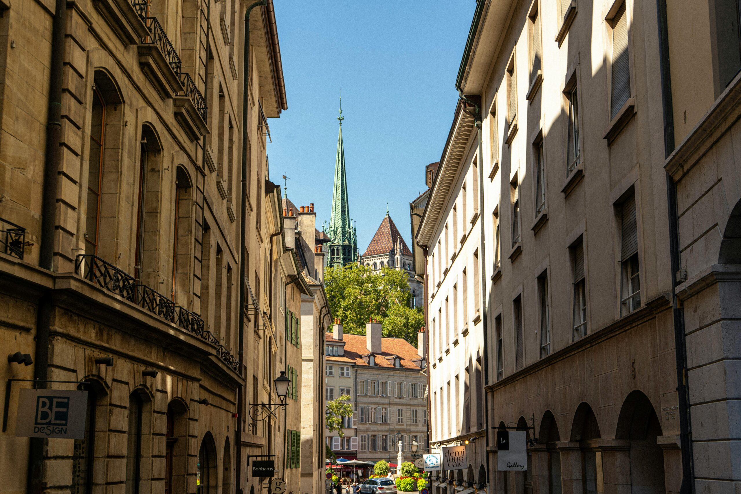A scenic view of Geneva's historic Old Town, featuring classic architecture and St. Pierre Cathedral's spire.
